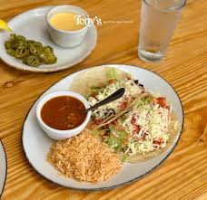 Tony's Mexican Restaurant signature dishes Queso Flameado, Fajitas, Enchiladas, Tacos al Carbon, Carne Guisada, and Birriadillas.